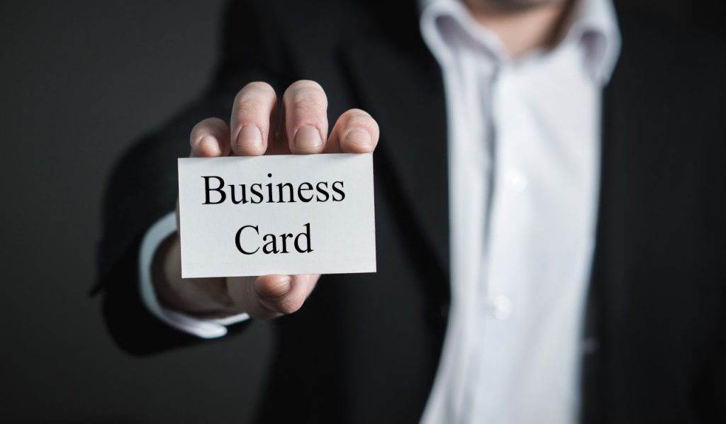 hand close up holding a business card