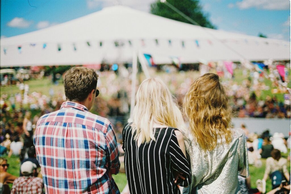 three people standing front of field